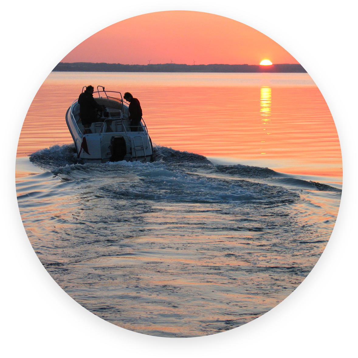 Boat on water at sunset