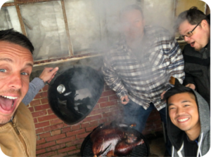 Venture Trailer employees cooking a smoked turkey